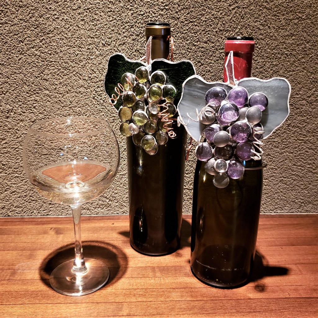 Wine Charms by It Ain't Plain By Jane on display with wine.